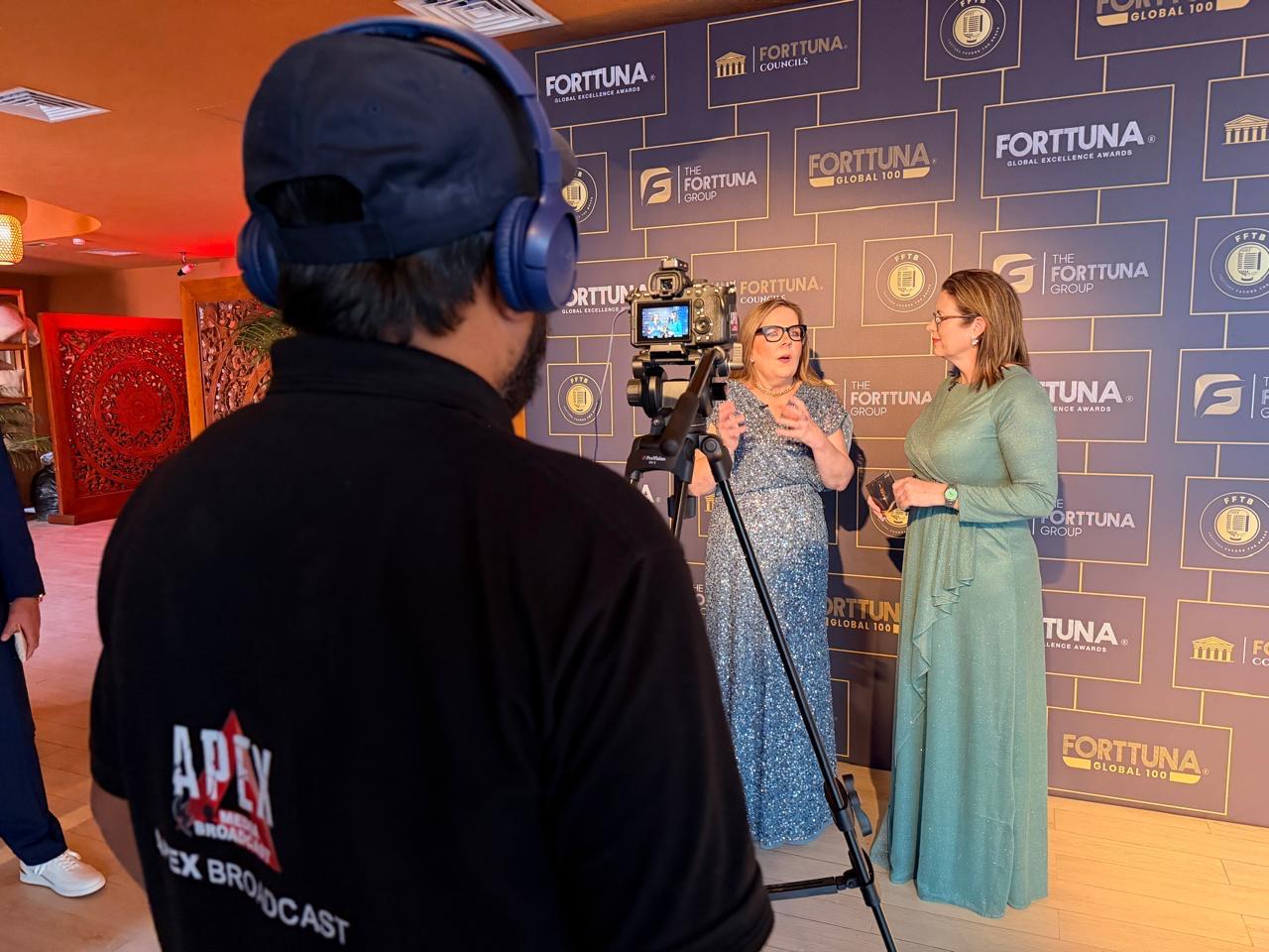 Apex camera operator filming an event interview